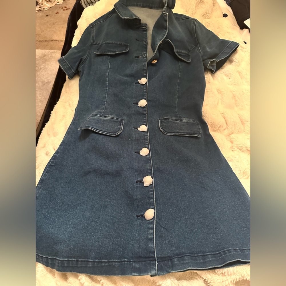 Commense dress.gold buttons but are still protected by paper.